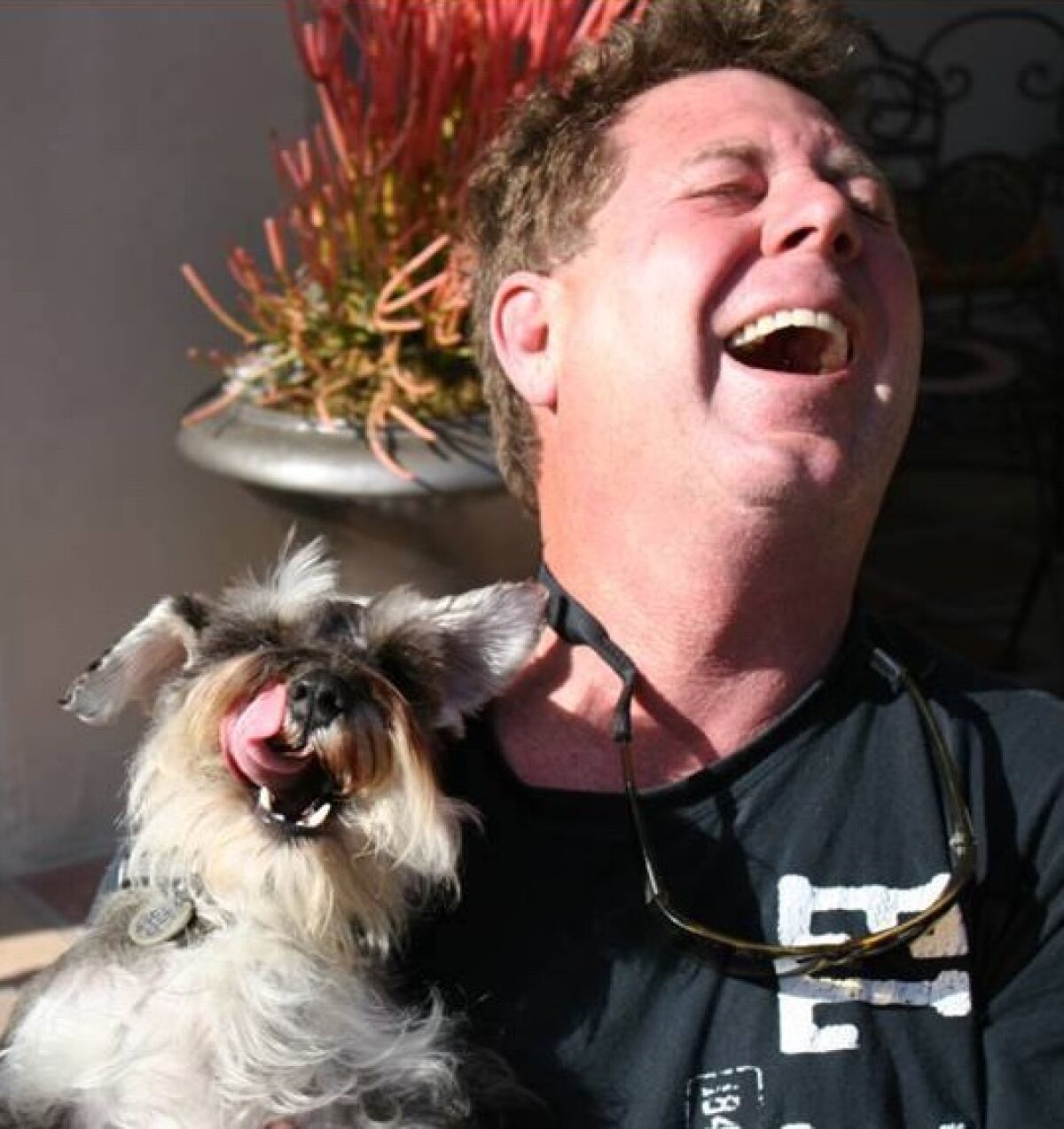 Chris Cott, pictured with one of his dogs, Gus, works to return lost dogs to their homes. 