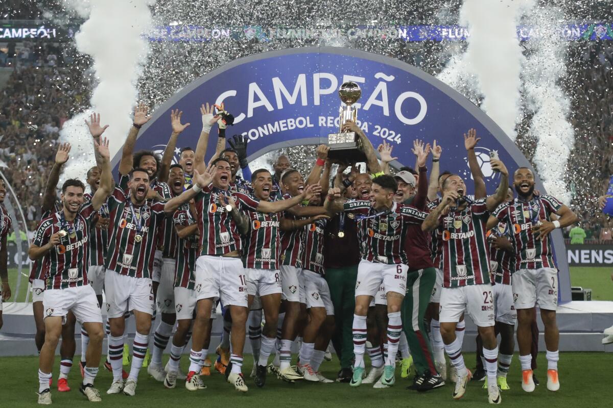 Players of Brazil's Fluminense celebrate with the trophy after winning the Recopa Sudamericana final soccer match against Ecuador's Liga Deportiva Universitaria at Maracana stadium in Rio de Janeiro, Brazil, Thursday, Feb. 29, 2024. (AP Photo/Bruna Prado)