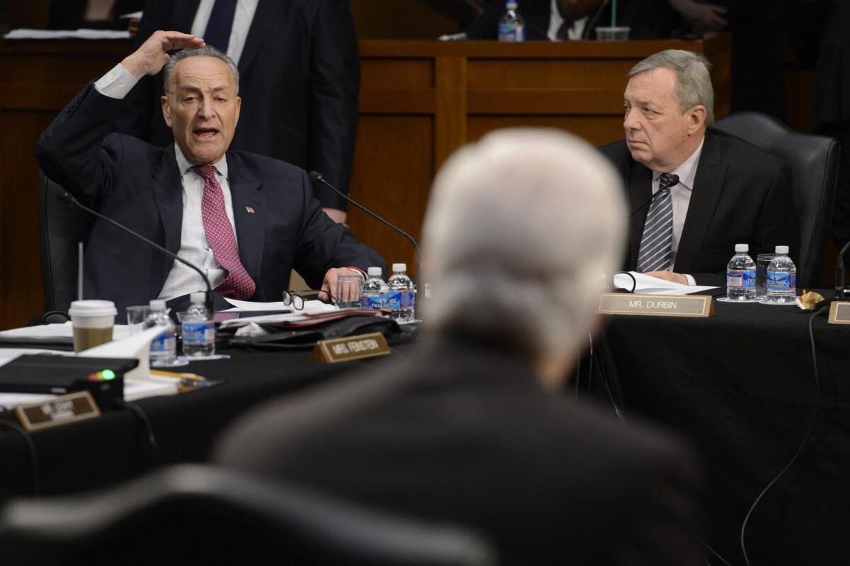 Chuck Schumer (D-N.Y.), left, delivers remarks toward Republican Senator John Cornyn (R-Texas), center, while Dick Durbin (D-Ill.) looks on during the Senate Judiciary Committee meeting to work on the legislation "Border Security, Economic Opportunity, and Immigration Modernization Act," on Capitol Hill in Washington.