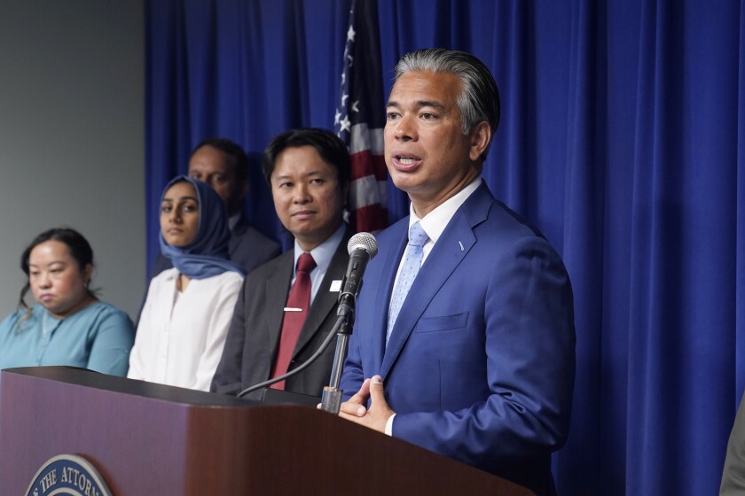 Attorney General Rob Bonta, right, discusses the rise in hate crimes in California in Sacramento on Tuesday.