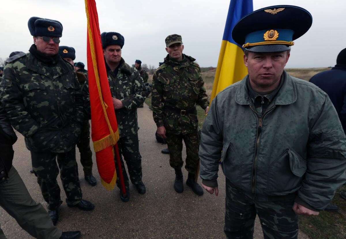 Col. Yuly Mamchur, right, commander of a Ukraine army unit guarding a military airport in Belbek on the Crimean peninsula, is shown at the base last week. On Thursday, he threatened to have his forces open fire on Russian troops holding part of the base.