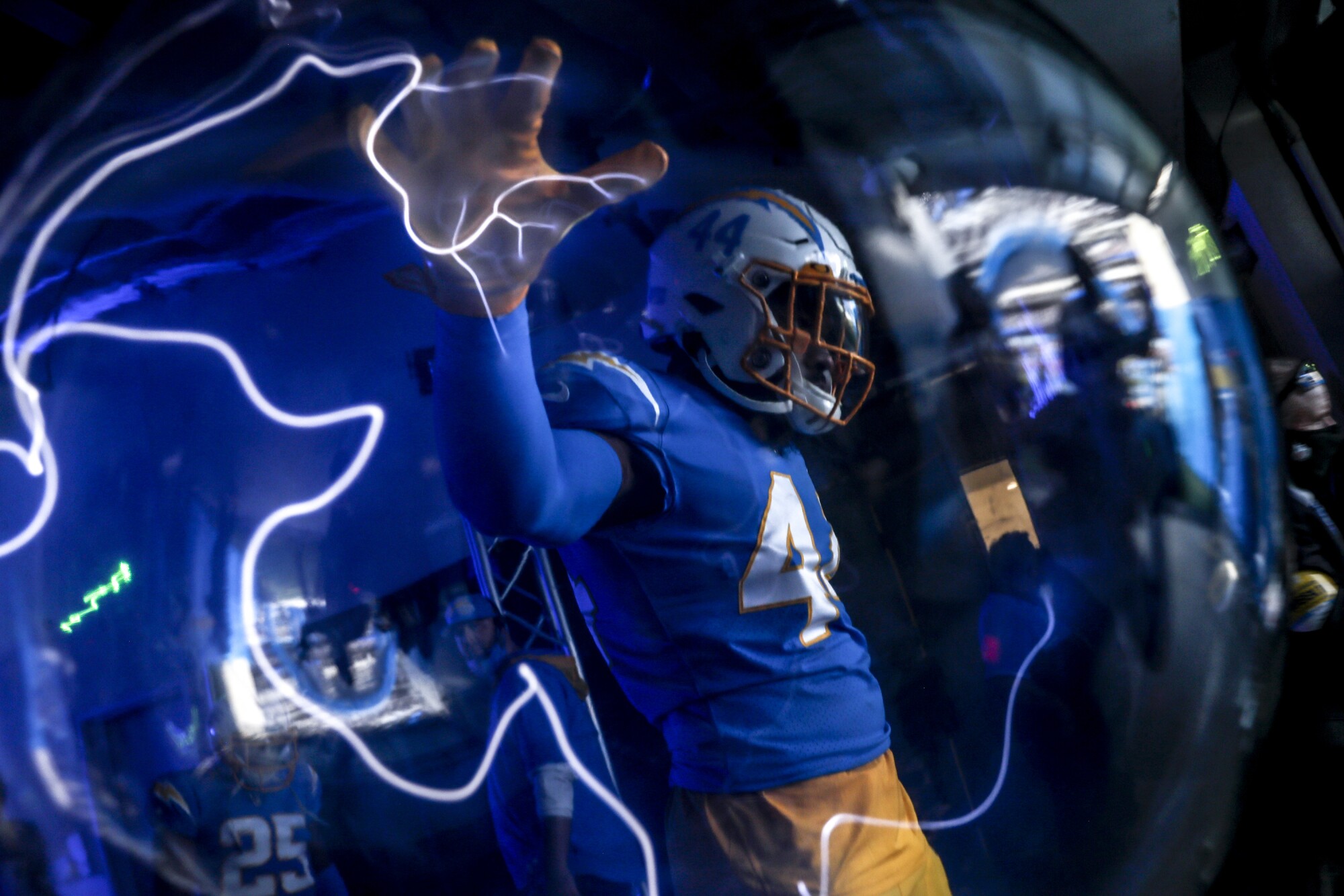 A football player touches a lightning orb.