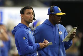 Los Angeles Rams linebackers/pass rush coordinator Chris Shula, left, is seen on the sidelines.