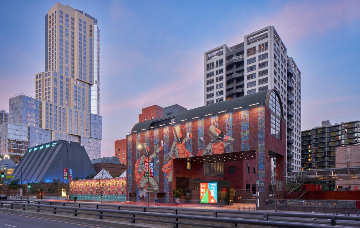 The exterior of a museum is covered in a mural of a marching band.