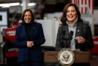 DETROIT, MI - OCTOBER 15: Vice President Kamala Harris smiles as Michigan Governor Gretchen Whitmer delivers remarks after touring a FOCUS: HOPE facility on Saturday, Oct. 15, 2022 in Detroit, MI. The Vice President is in Michigan for events to highlight the administrations work ahead of the midterm election. (Kent Nishimura / Los Angeles Times)