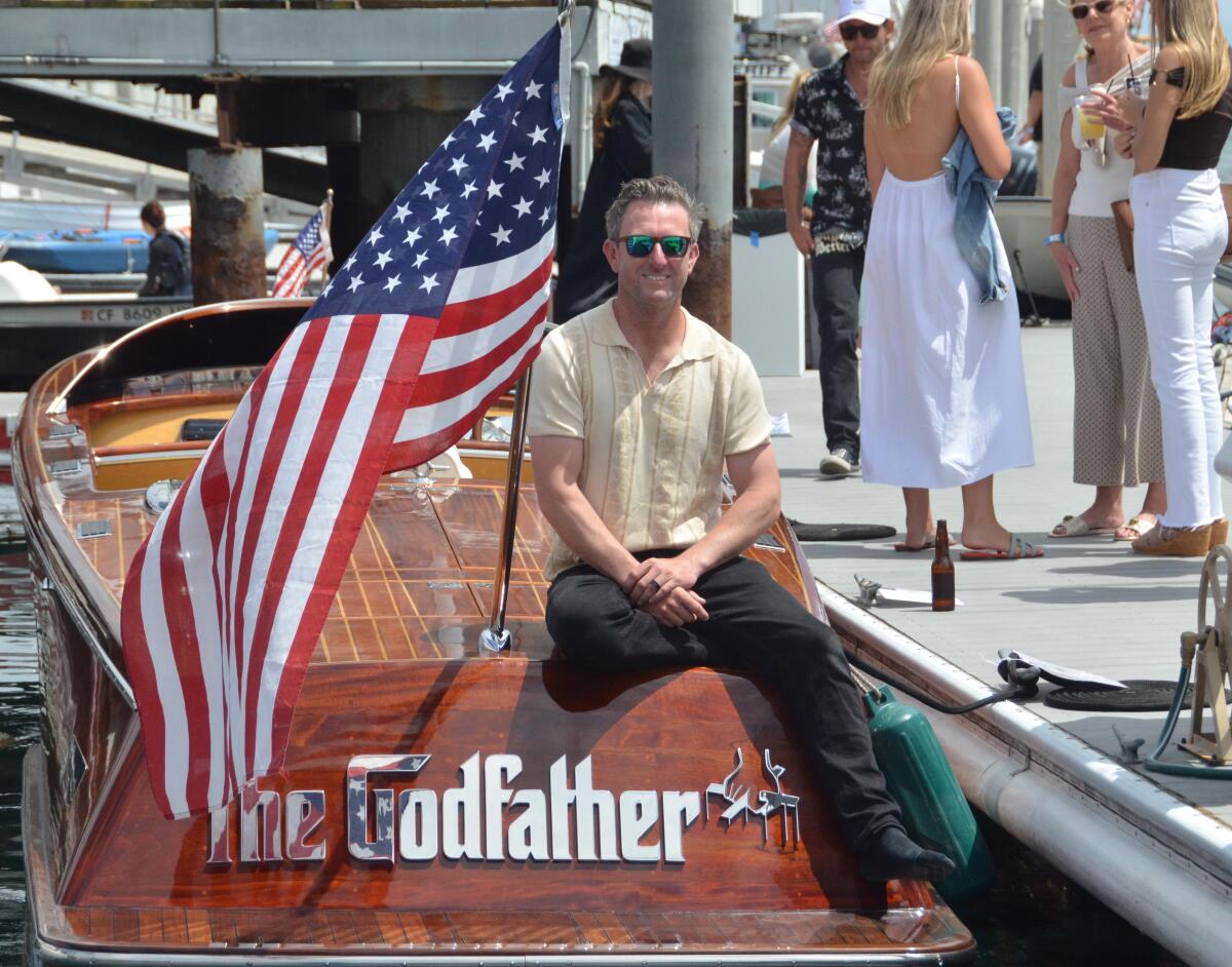 Evan Krisher displays his 28-foot mahogany-carbon runabout, the Godfather.
