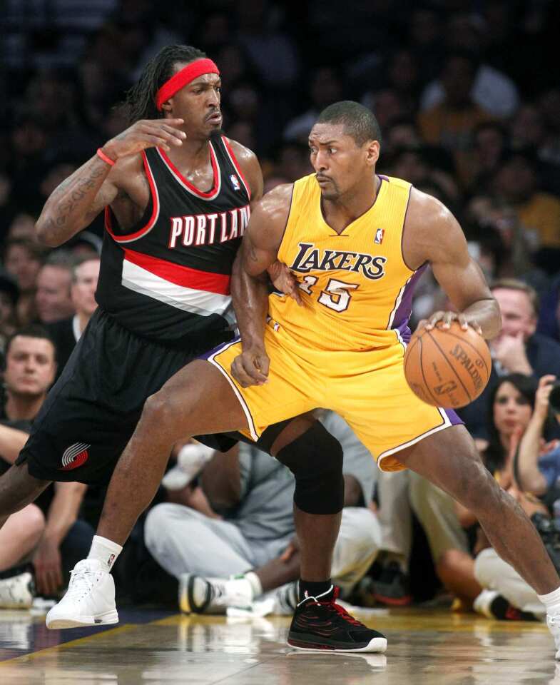 Lakers forward Metta World Peace looks for a scoring opportunity against Blazers forward Gerald Wallace during their game Monday night at Staples Center.