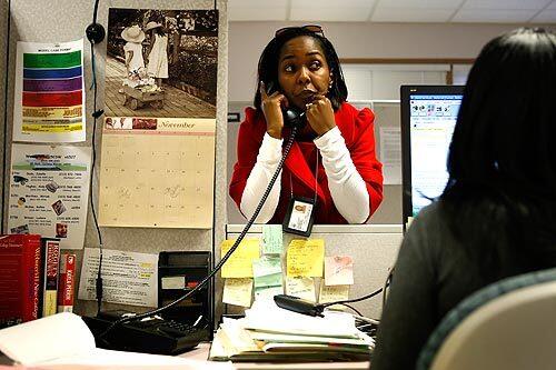 Veteran social worker Wendy Luke works the phone at her Hawthorne office as she investigates a case.
