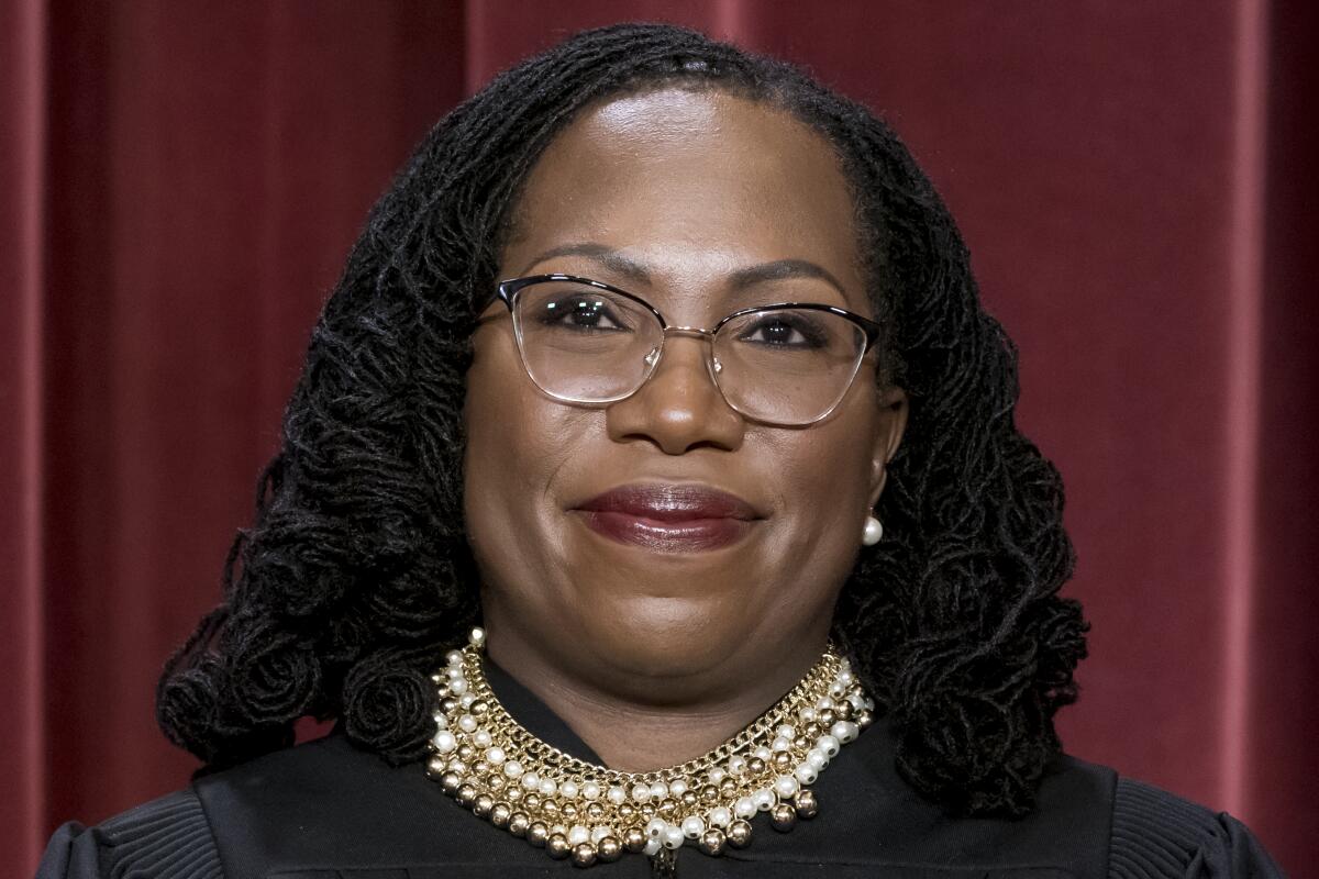 FILE - Associate Justice Ketanji Brown Jackson stands as she and members of the Supreme Court pose for a new group portrait following her addition, at the Supreme Court building in Washington, Oct. 7, 2022. (AP Photo/J. Scott Applewhite, File )DCSA122
