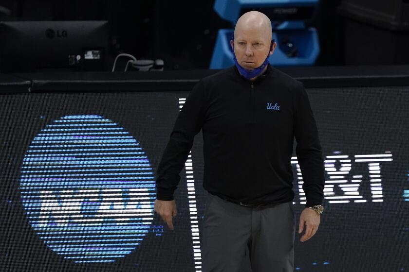 UCLA head coach Mick Cronin watches from the bench during the first half of a men's Final Four NCAA college basketball tournament semifinal game against Gonzaga, Saturday, April 3, 2021, at Lucas Oil Stadium in Indianapolis. (AP Photo/Michael Conroy)