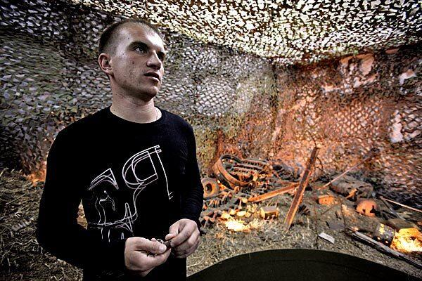 Heroin addict Anton, 28, who has been off the drug for more than a year since he joined the Country of the Living Center in Podolsk, near Moscow, stands in the war museum of the center. As part of their therapy, the center's patients take part in excavations of the remains of unburied WWII soldiers in Russia.