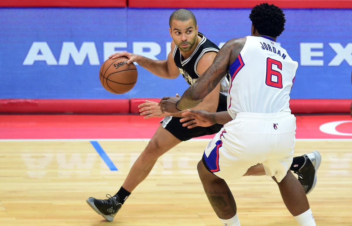 San Antonio's Tony Parker looks to pass under pressure from Clippers' DeAndre Jordan on Wednesday night.