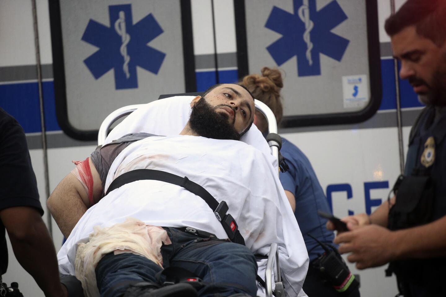 Ahmad Khan Rahami is taken into custody after a shootout with police Monday, Sept. 19, 2016, in Linden, N.J.