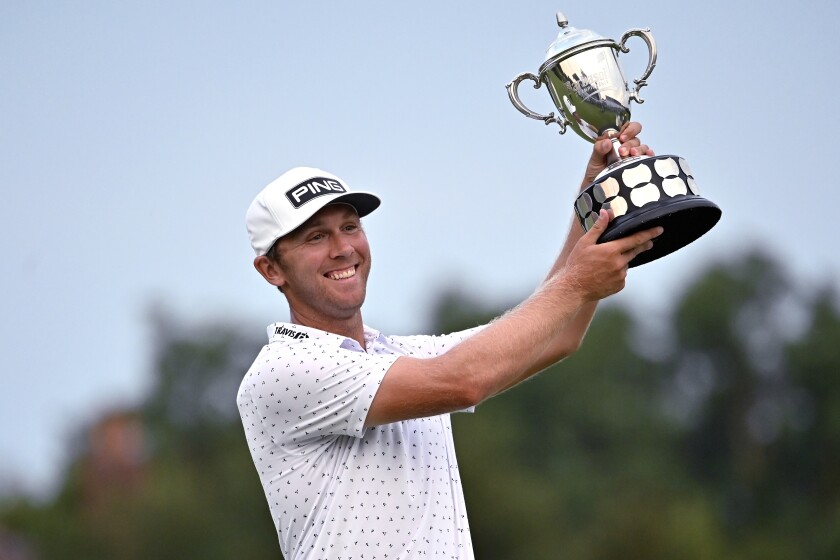 Seamus Power holds up the trophy following his victory in the Barbasol Championship golf tournament at Keene Trace in Nicholasville, Ky., Sunday, July 18, 2021. Power's victory over J.T. Poston came after six playoff holes. (AP Photo/Timothy D. Easley)