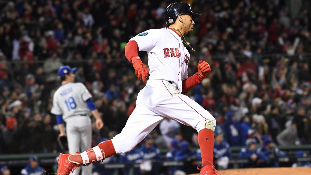 As Dodgers pitcher Kenta Maeda looks on, Mookie Betts hits a double for Boston in Game 2 of the 2018 World Series.