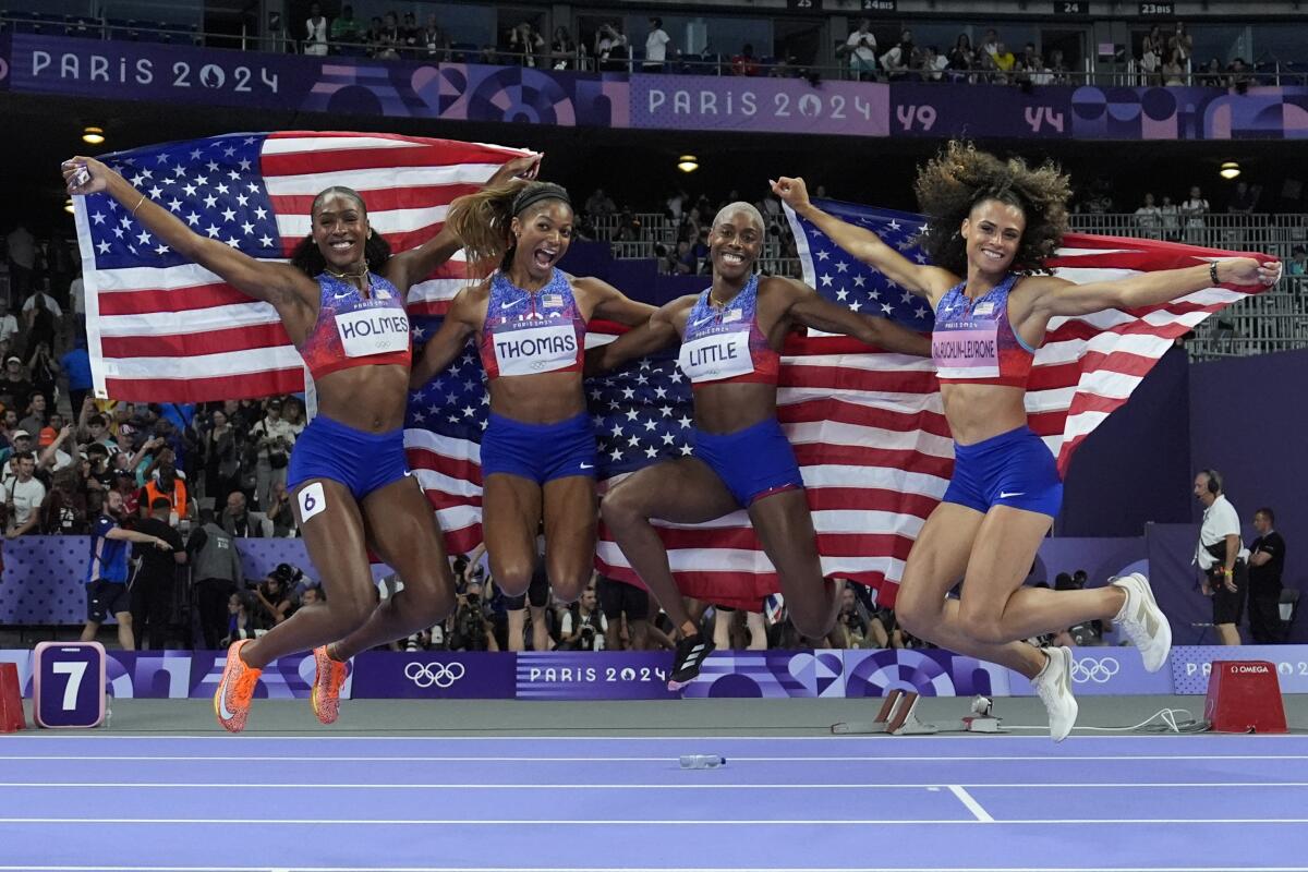 The United States' women 4x400-meter relay team celebrates winning the gold medal at the 2024 Summer Olympics 