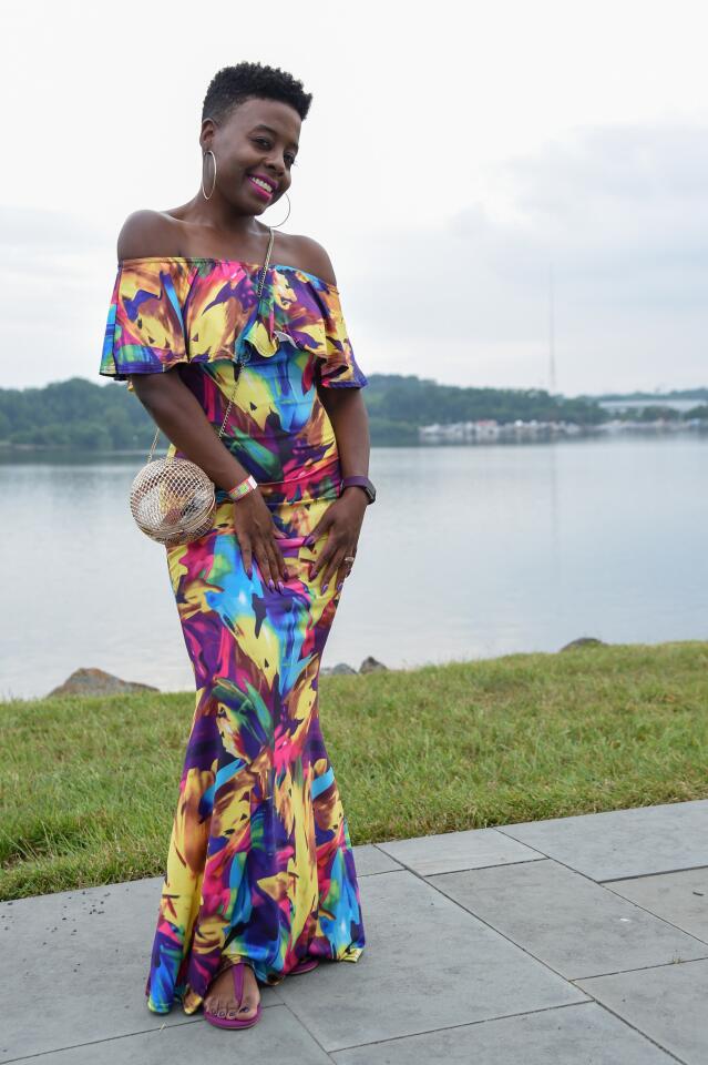 Who: Monique Bryant, 40, West Baltimore resident, US Department of Defense contract analyst Spotted at: Jazzy Summer Nights at West Covington Park What she wore: Neon multi-color off-the-shoulder maxi-dress from amazon.com; H&M electric purple suede flat sandals; rose gold mesh sphere crossbody bag from asos.com; Fitbit; and gold hoop earrings from a beauty supply store. “She is truly Monique chic”: “I’ve known her for over 20 years and she’s always had a strong sense of fashion,” said friend Tiffany Boykin.
