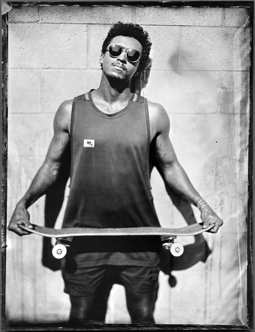 May 4: A man holds a skateboard in a black and white photo