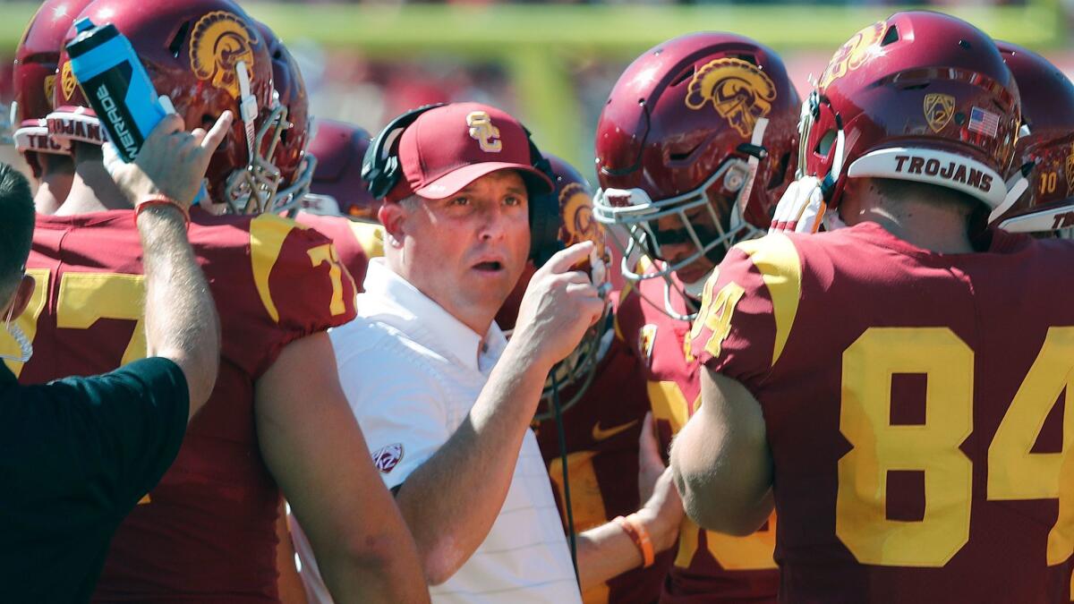 USC coach Clay Helton talks to his players during a game against Oregon State on Oct. 7.