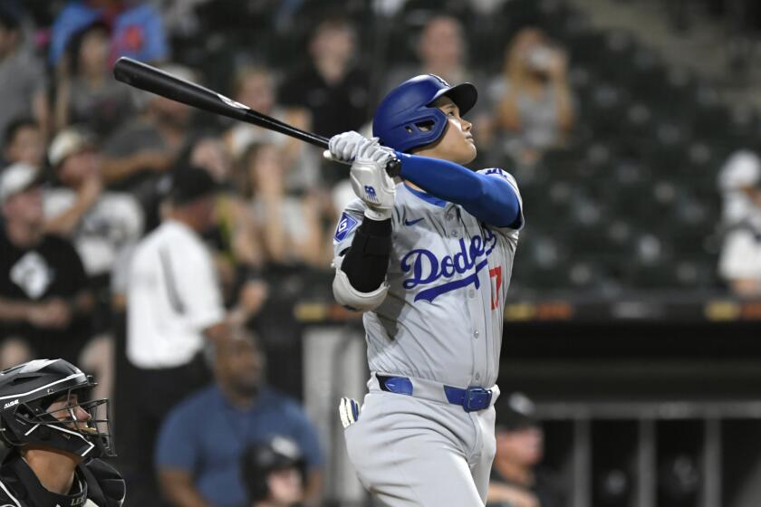 Los Angeles Dodgers' Shohei Ohtani (17) watches his RBI sacrifice fly during the ninth inning of a baseball game against the Chicago White Sox, Monday, June 24, 2024, in Chicago. Los Angeles won 3-0. (AP Photo/Paul Beaty)