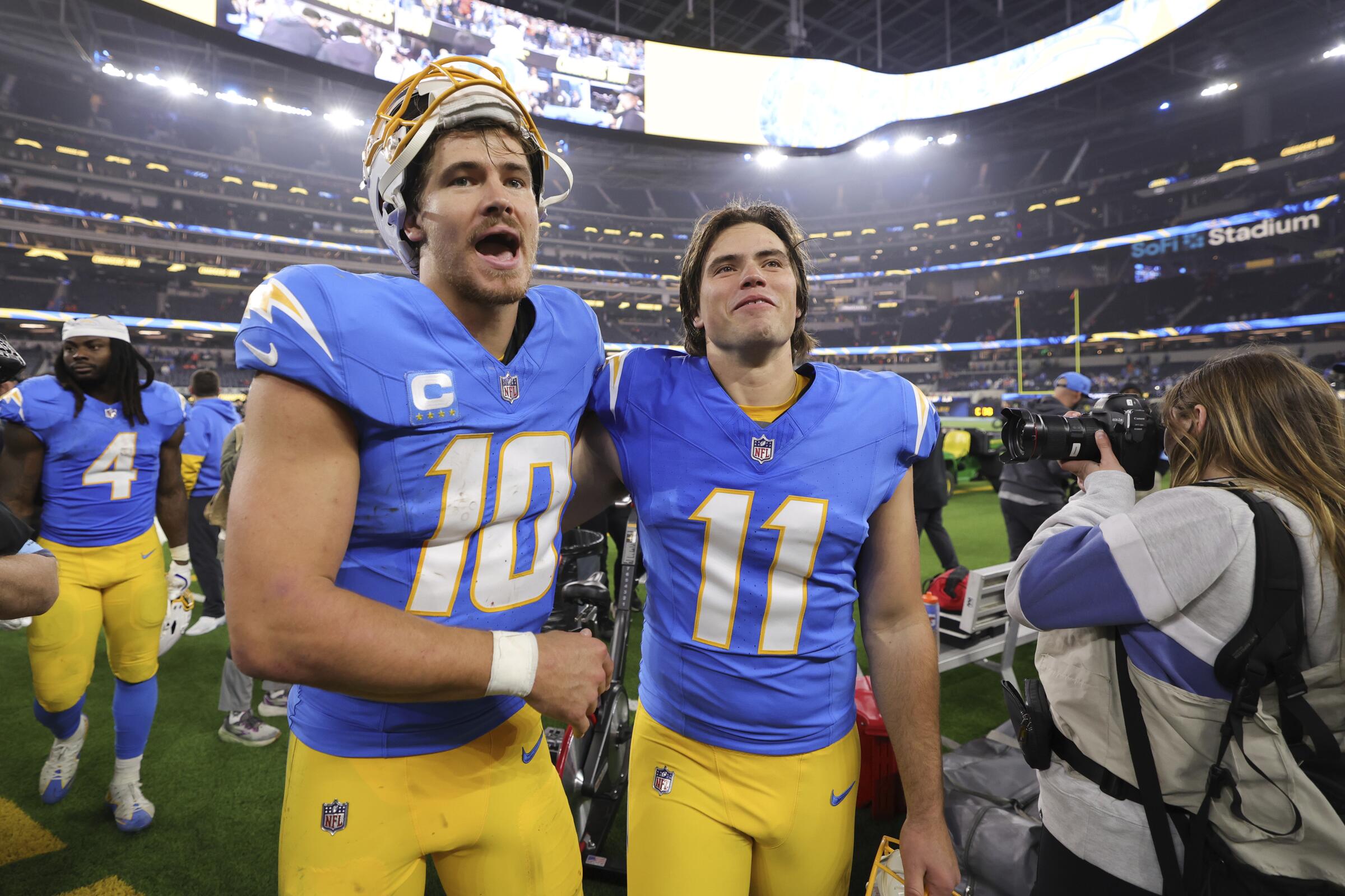 Chargers quarterback Justin Herbert, left, puts an arm around kicker Cameron Dicker after a win over the Broncos.