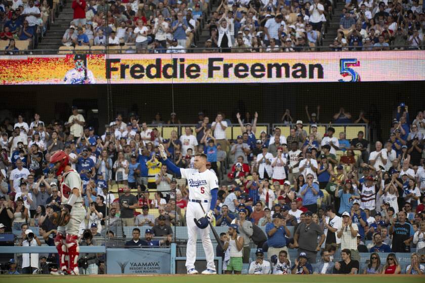 Freddie Freeman waves to the stands during the first inning