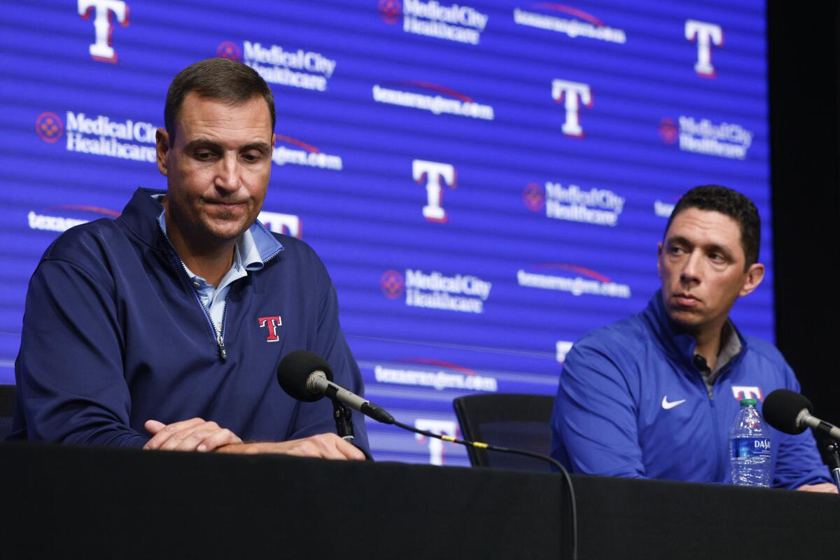 Texas Rangers general manager Chris Young, left, and Rangers President of Baseball Operations Jon Daniels listen to a question during a news conference after announcing the firing of manager Chris Woodward, Monday, Aug. 15, 2022, in Arlington, Texas. (Elías Valverde II/The Dallas Morning News via AP)