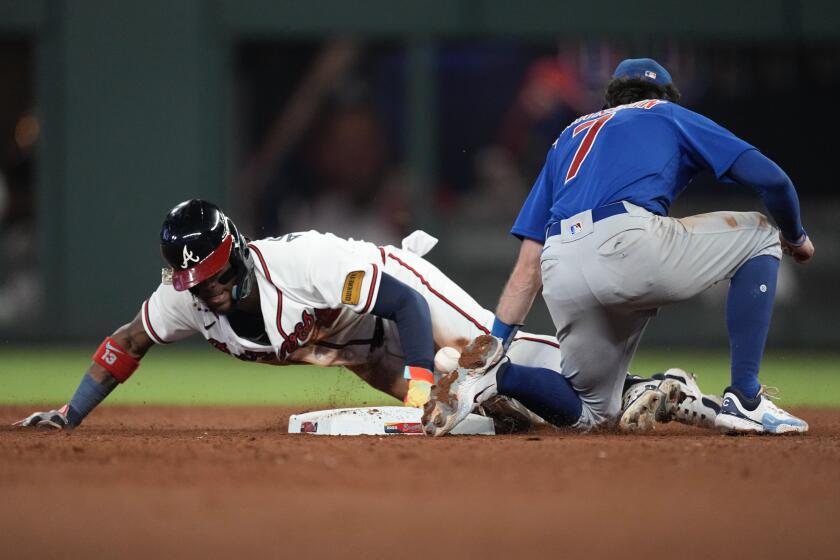Atlanta Braves' Ronald Acuna Jr. (13) steals second base as the ball gets away from Chicago Cubs shortstop Dansby Swanson 