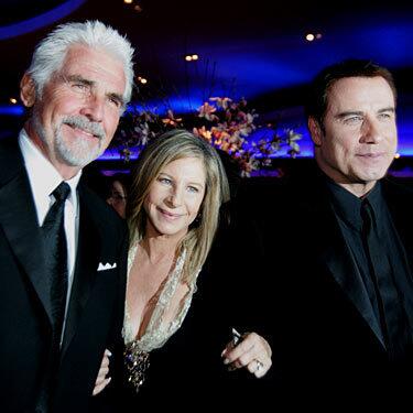 James Brolin, left, his wife, Barbra Streisand, and John Travolta beam at the Governors Ball.