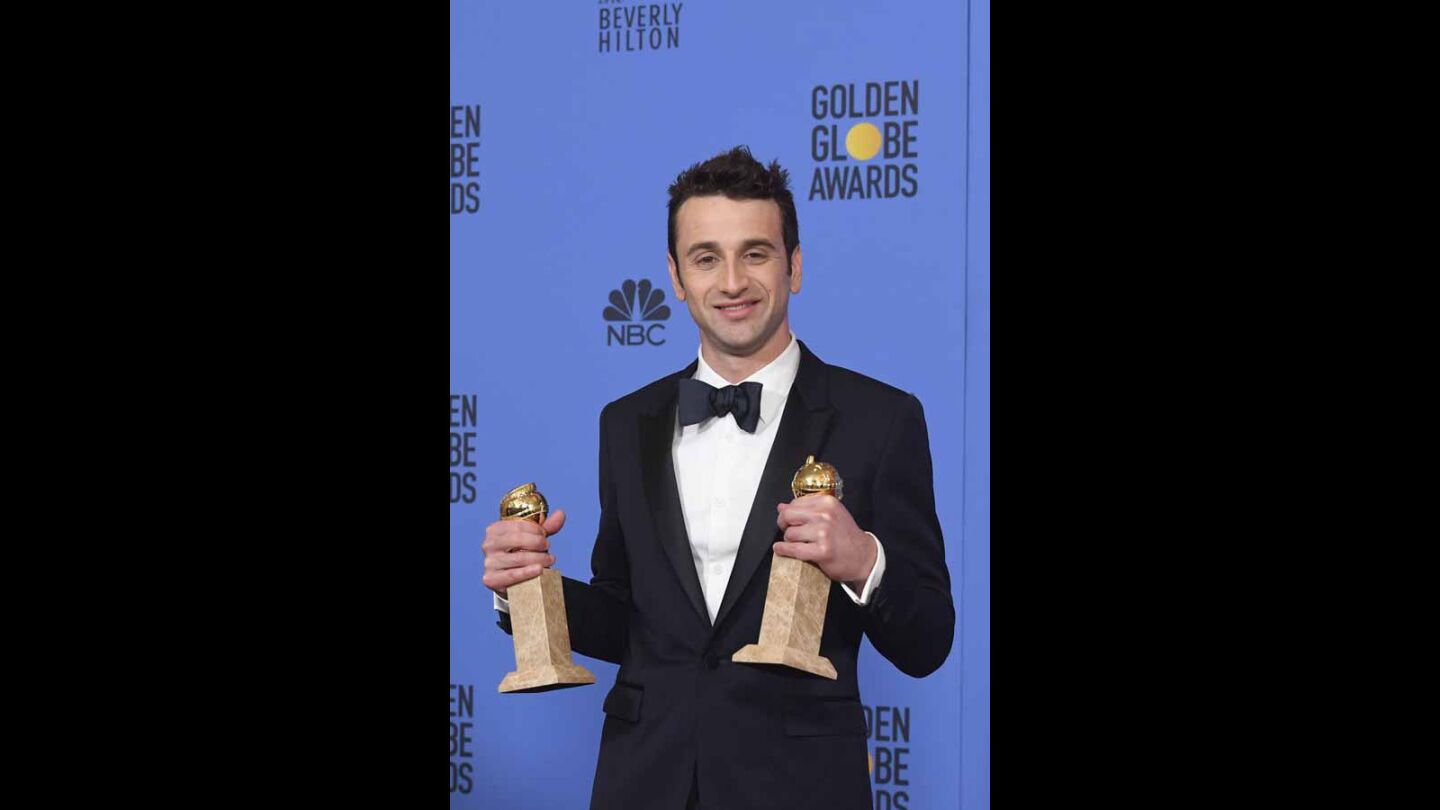 Composer Justin Hurwitz with his awards for original score and original song ("City of Stars") for "La La Land."