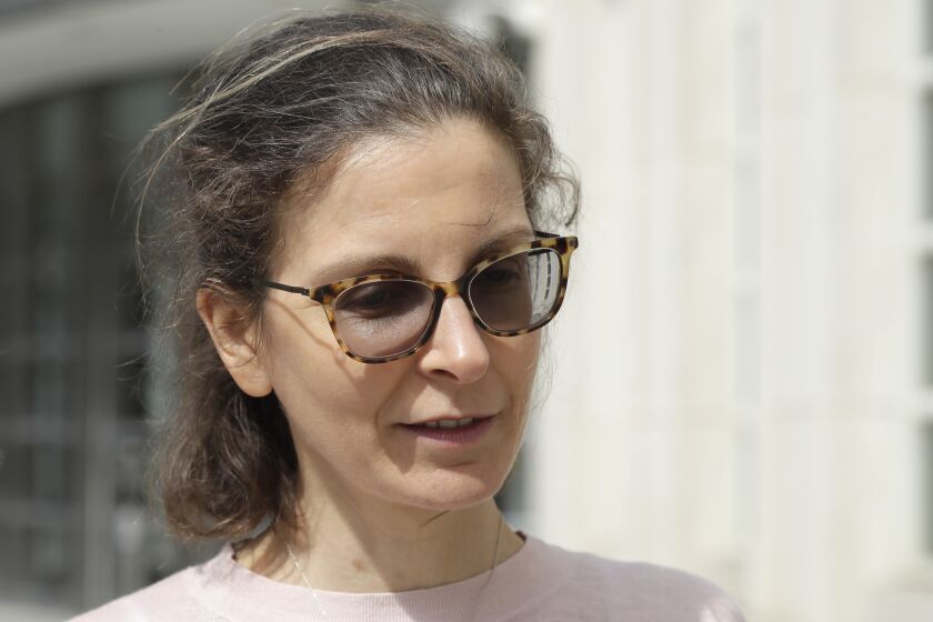 FILE - In this April 8, 2019, file photo, Seagram's liquor fortune heiress Clare Bronfman leaves Brooklyn Federal Court, in New York. Bronfman, the wealthy benefactor of Keith Raniere, the disgraced leader of a self-improvement group in upstate New York convicted of turning women into sex slaves branded with his initials, will be in court, on Wednesday, Sept. 30, 2020, for sentencing on federal conspiracy charges. (AP Photo/Mark Lennihan, File)