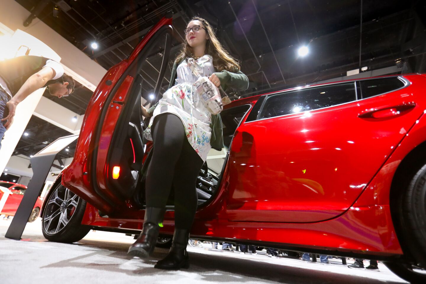Christina Clark of Chula Vista, gets out of a 2020 Kia Stinger GT2 during the 2020 San Diego International Auto Show at the San Diego Convention Center, January 4, 2020.