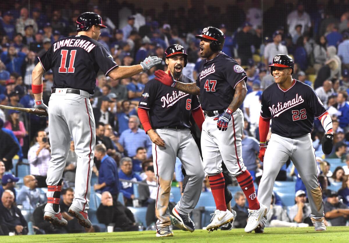 Howie Kendrick is greeted at home plate after his grand slam.