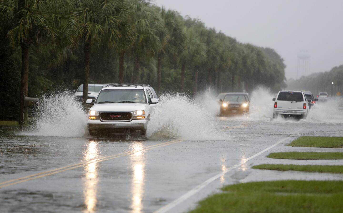 Cars make their way through Palm Boulevard on the Isle of Palms while the South Carolina coast is inundated with historic rain causing flooding on Saturday.