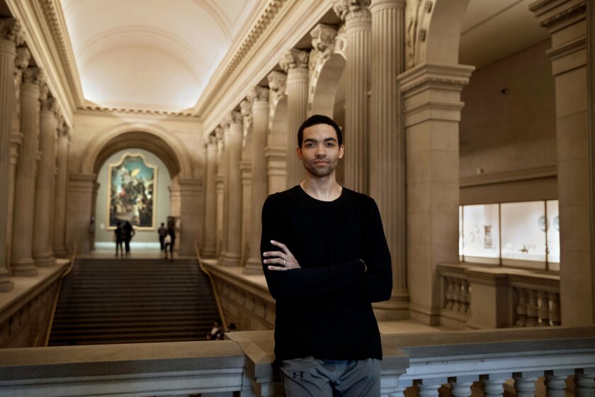 A man poses inside the Met Museum