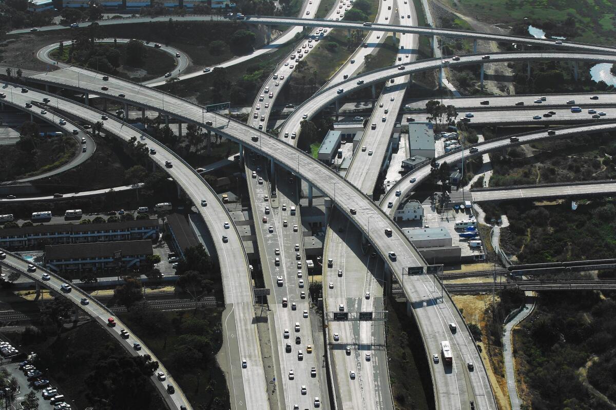 Traffic flows through the interchange of Interstates 5 and 8 in San Diego. The city's Climate Action Plan requires annual emissions be cut in half during the next two decades.