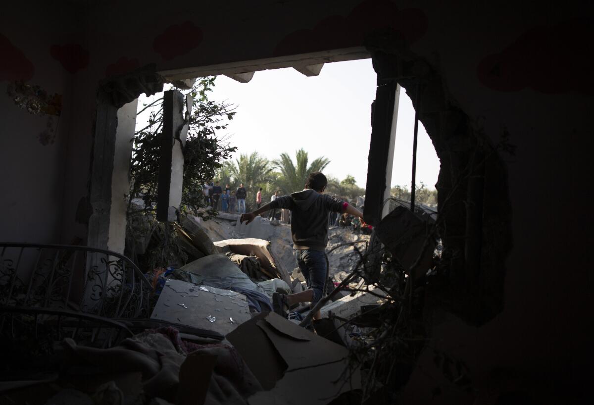 A Palestinian boy walks walks through a home in the Gaza Strip that was destroyed during Israeli airstrikes.