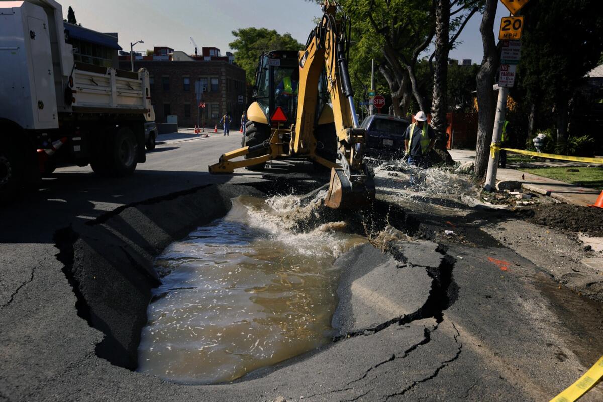 DWP workers repair a sinkhole on Formosa Avenue in West Hollywood that was caused by a water main break.