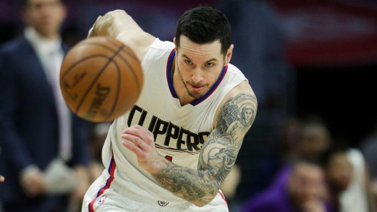 Clippers' J.J. Redick goes after a loose ball during the first half of a game against the Lakers on Jan. 14.