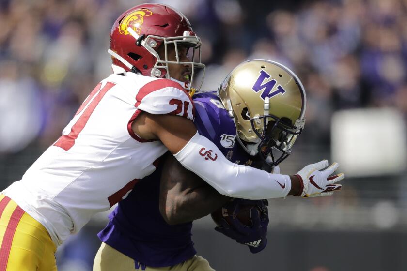 Southern Cal's Isaiah Pola-Mao tackles Washington's Chico McClatcher in the first half of an NCAA college football game Saturday, Sept. 28, 2019, in Seattle. (AP Photo/Elaine Thompson)
