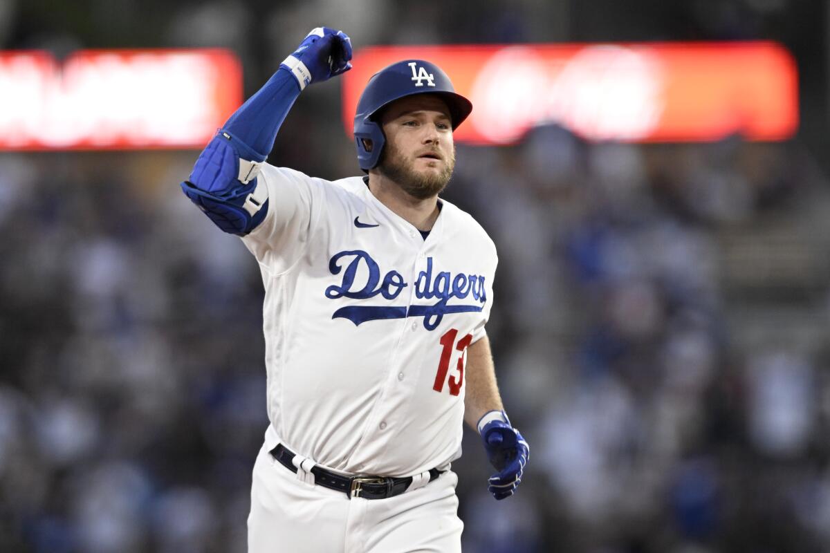 Dodgers' Max Muncy celebrates while rounding second base on a solo home run against the Cincinnati Reds on July 29, 2023.