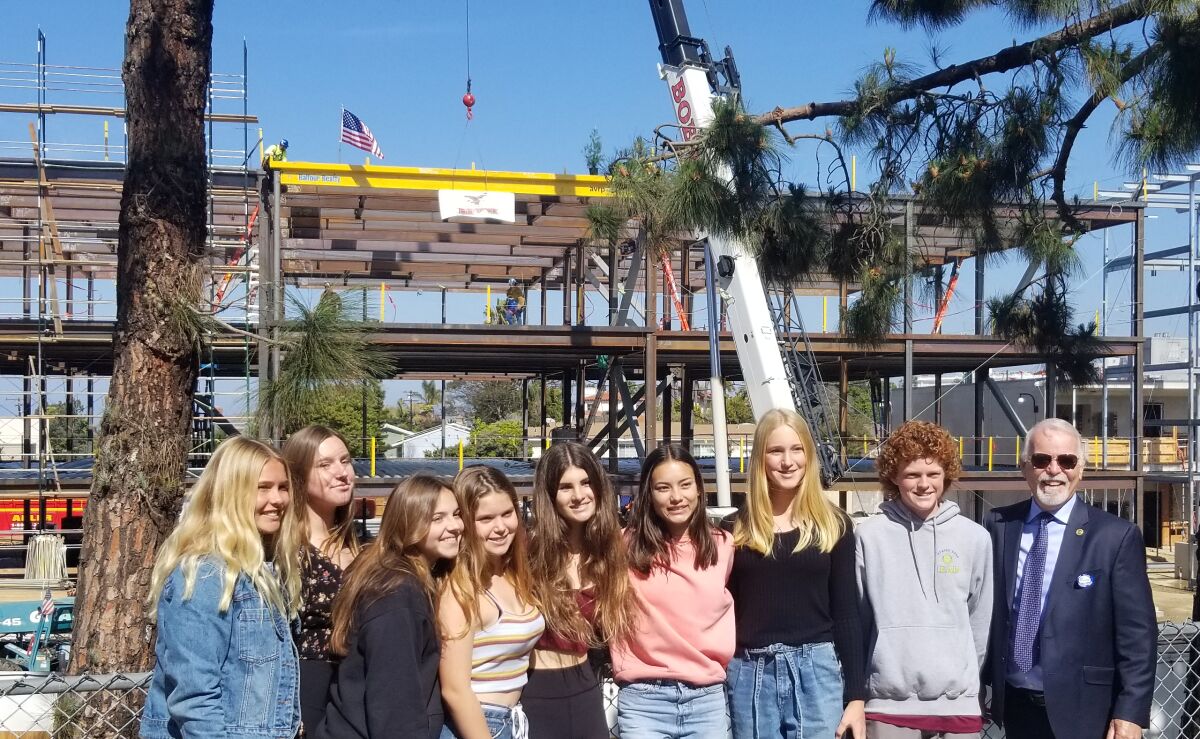 A group of Point Loma High School freshmen — along with Dr. Mike McQuary (right), a San Diego Unified Board of Education trustee — pose in front of the up-and-coming 800 Building they will get to enjoy in their future years at PLHS.