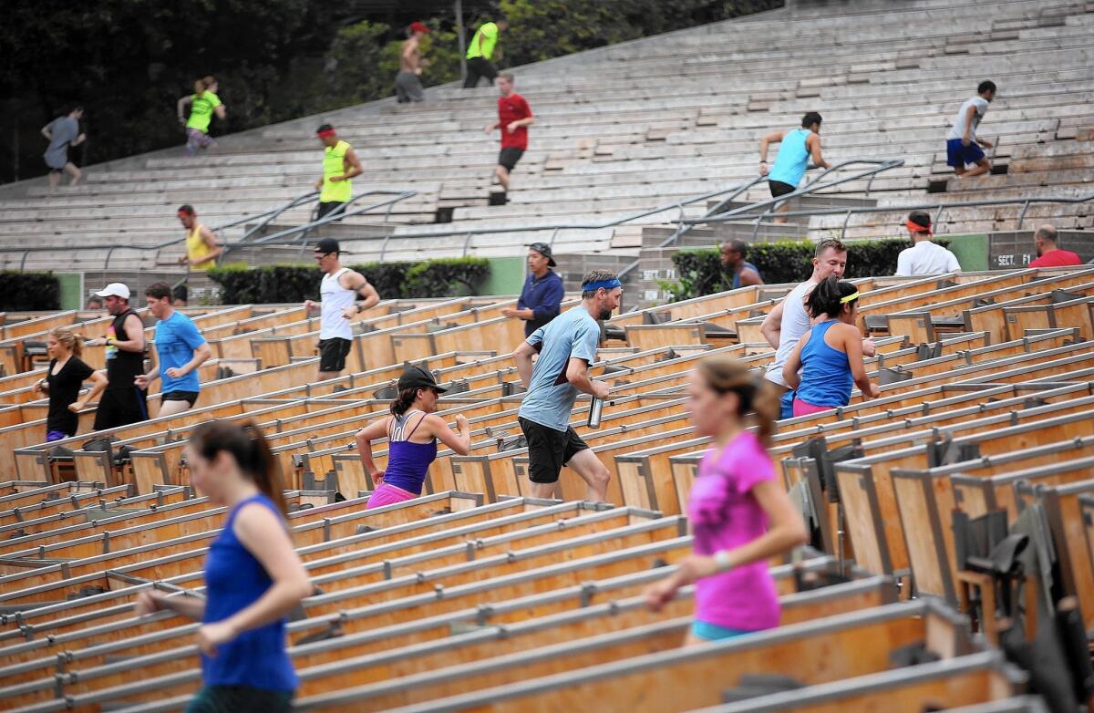 Runners switch aisles on their way up and down the steps of the Hollywood Bowl with the November Project in Los Angeles.