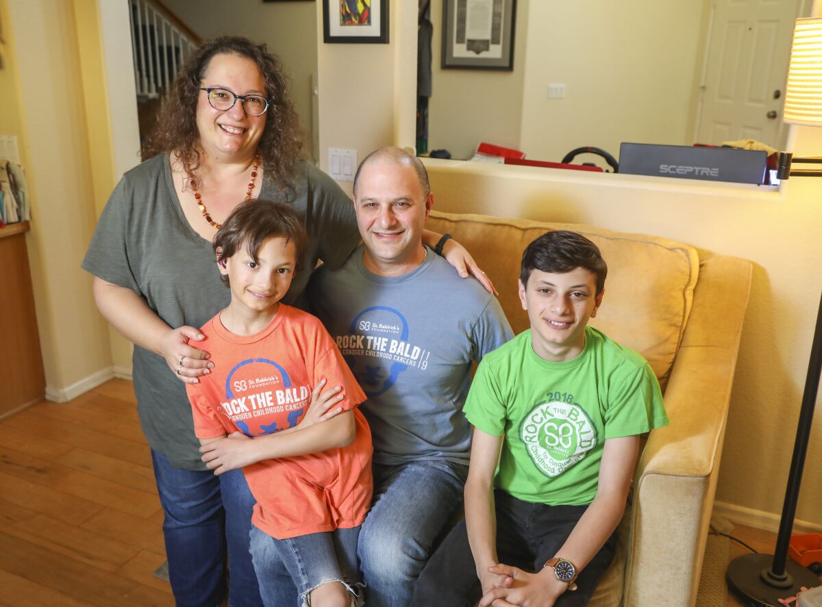 The Bernstein family: Kate, 45, Micah, 9, Jeff, 44, and Asher, 12, pose for a photo at their Carlsbad home on Jan. 10. Micah has been chosen as one of five 2020 ambassadors for the St. Baldrick's Foundation children's cancer charity.