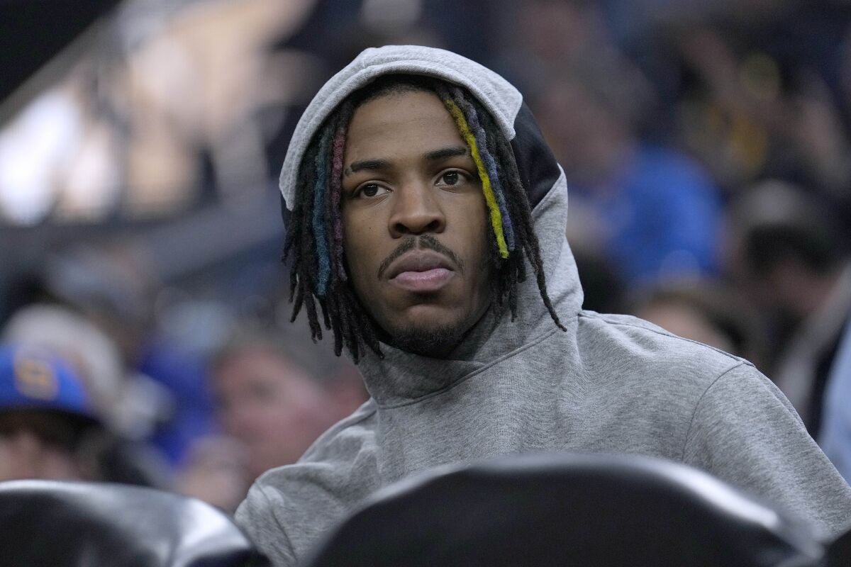 Memphis Grizzlies guard Ja Morant watches from the bench during the first half against the Golden State Warriors in Game 4 of an NBA basketball Western Conference playoff semifinal in San Francisco, Monday, May 9, 2022. Morant was injured and did not play. (AP Photo/Tony Avelar)