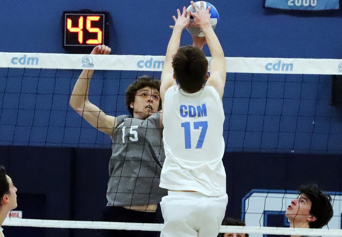 Newport Harbor's Jack Berry (15) and CdM's Ryan Grant (17) joust for the ball during Friday's match.