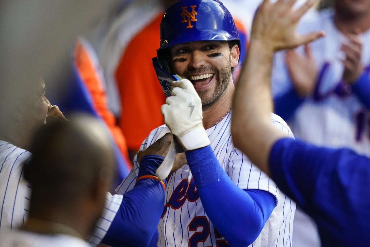 New York Mets' Tyler Naquin celebrates with teammates after hitting a home run during the second inning of the team's baseball game against the Atlanta Braves on Thursday, Aug. 4, 2022, in New York. (AP Photo/Frank Franklin II)