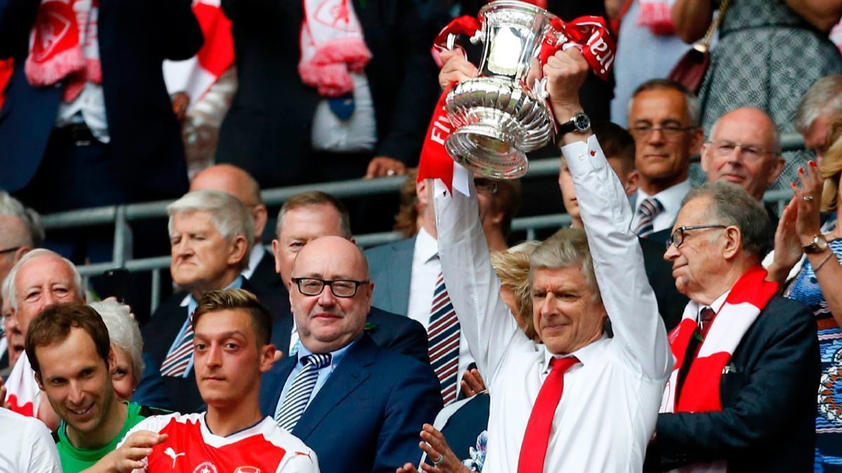 Arsenal's manager Arsene Wenger lifts the FA Cup trophy after their win over Chelsea in the English FA Cup final on Saturday.