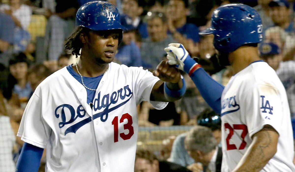 Dodgers shortstop Hanley Ramirez, left, is congratulated by teammate Matt Kemp after scoring a run against the Padres in the sixth inning Thursday.