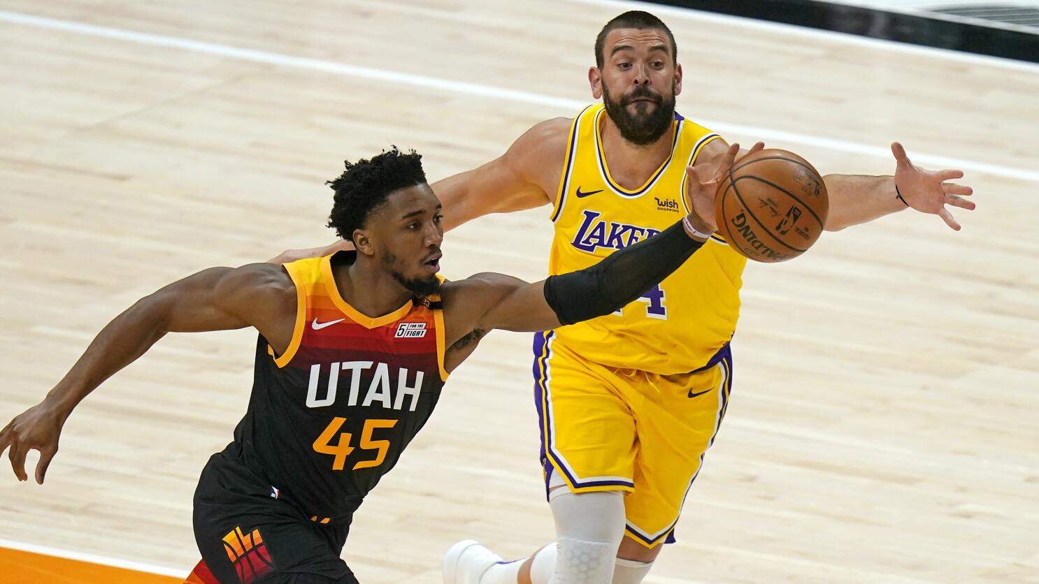 Los Angeles Lakers forward LeBron James, right, dunks past Charlotte  Hornets guard LaMelo Ball (2) during the first half of an NBA basketball  game Thursday, March 18, 2021, in Los Angeles. (AP